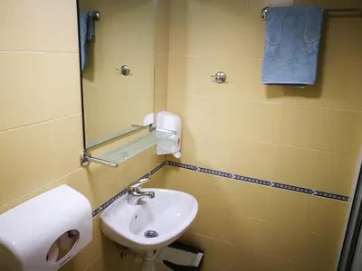 a bathroom with a sink and a mirror at Hotel Paradise in Sofia