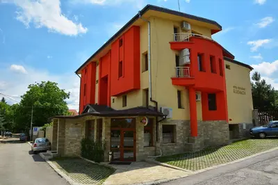 a building with an orange and yellow at Eleganza Family Hotel - Free Parking in Sofia