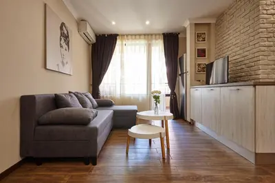 a living room with a couch and a table at City Center Studio in Plovdiv