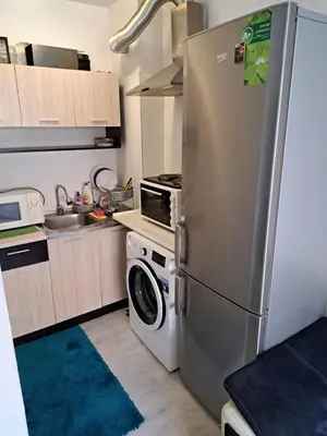 a kitchen with a refrigerator and a washing machine at Sun Стамат Икономов 11 in Plovdiv