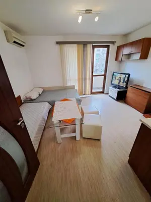 a room with a bed and a table in it at spa in Plovdiv