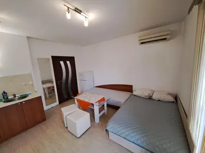 a small bedroom with a bed and a table at spa in Plovdiv