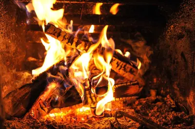 a fire in a fireplace with flames in it at Guest House Dzhangal in Bansko