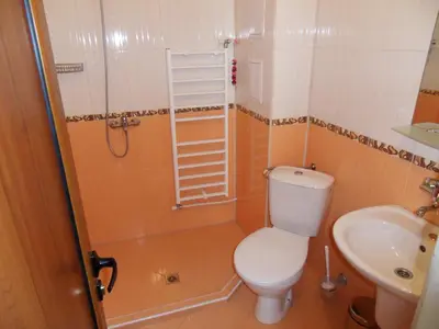 a bathroom with a toilet and a sink at Family Hotel Nadejda in Bansko