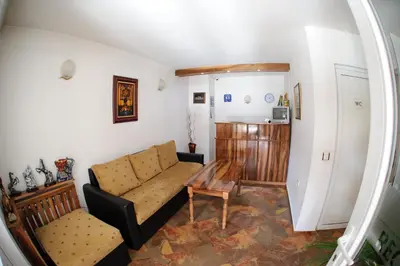 a living room with a couch and a table at Family Hotel Nadejda in Bansko