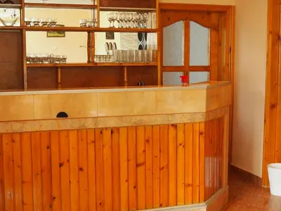 a bar in a restaurant with wooden walls at Орбелус in Govedartsi