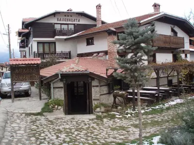a building with a horse standing in front of it at Guest House Valevicata in Bansko