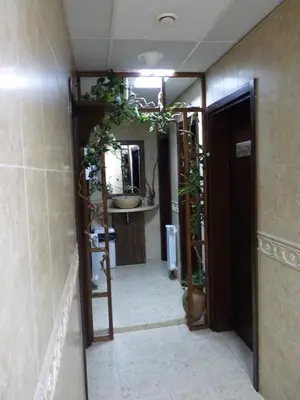 a hallway with a bathroom with a mirror and plants at Molerite Complex in Bansko
