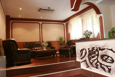a living room with leather chairs and a couch at Hotel Alafrangite in Plovdiv