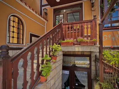 a wooden staircase with potted plants on it at Family Hotel at Renaissance Square in Plovdiv