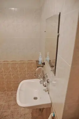 a bathroom with a white sink and a mirror at Hello Sofia Guesthouse in Sofia