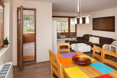 a living room and dining room with a table and chairs at Апартамент 