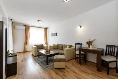 a living room with a couch and a table at Grand Royale Apartment Complex & Spa in Bansko