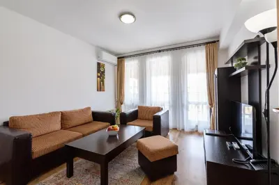 a living room with a couch and a table at Grand Royale Apartment Complex & Spa in Bansko