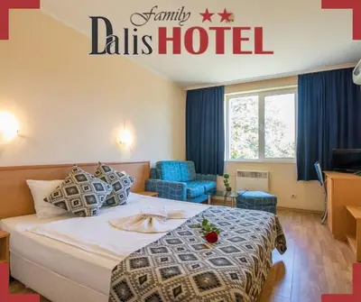a hotel room with a large bed and blue chairs at Family Hotel Dalis in Sofia