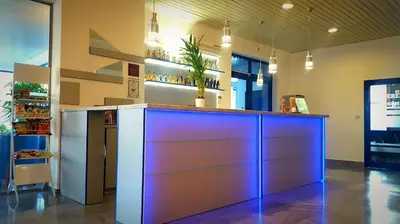 a bar in a restaurant with a blue lighting at Family Hotel Dalis in Sofia