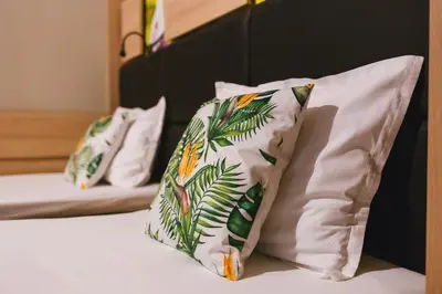 two pillows sitting on top of a bed at Hotel Allur in Plovdiv