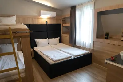 a small room with two bunk beds and a window at Hotel Allur in Plovdiv