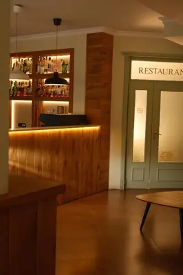 a bar in a restaurant with a sign that reads restaurant at Family Hotel Ramira in Kyustendil