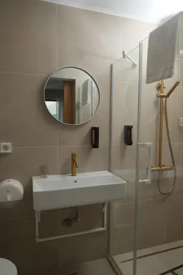 a bathroom with a sink and a mirror at Family Hotel Ramira in Kyustendil