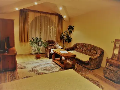 a living room with a couch and a table at Boyadjiyski Guest House in Bansko