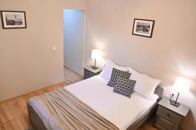 a bedroom with a bed with two lamps on it at Klecherova House in Bansko
