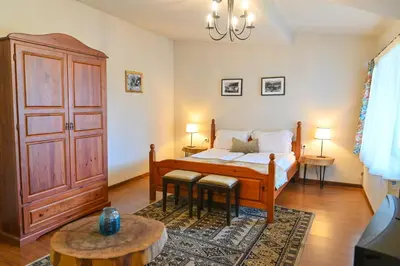 a bedroom with a bed and two tables in a room at Klecherova House in Bansko