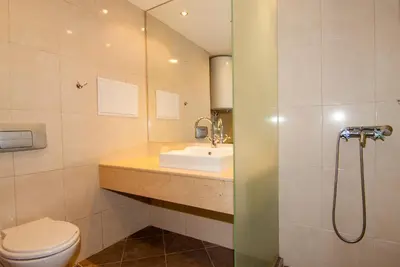 a bathroom with a sink and a toilet at Апартаменти Малина in Pamporovo
