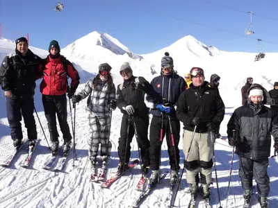 a group of people posing for a picture on a ski slope at Hotel Alpin - 91 Bansko in Bansko