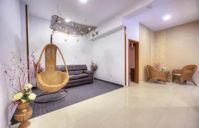 a living room with a couch and a swing at MPM Family Hotel Merryan in Pamporovo