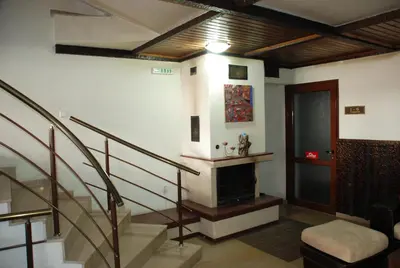 a living room with stairs and a stair case at Apart Hotel Comfort in Bansko
