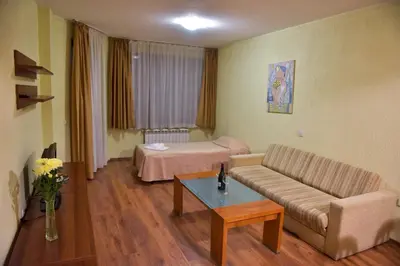 a living room with a couch and a bed at Apart Hotel Comfort in Bansko