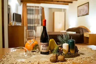 a table with a bottle of wine and a glass at Matsurev Han in Bansko