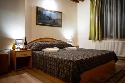 a bedroom with a bed with two towels on it at Matsurev Han in Bansko