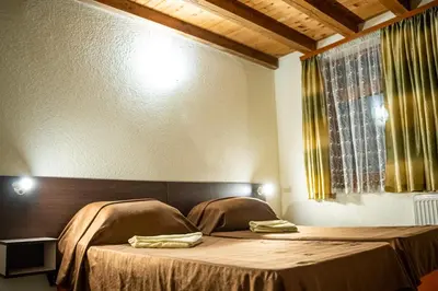 a bedroom with a bed with two pillows on it at Matsurev Han in Bansko