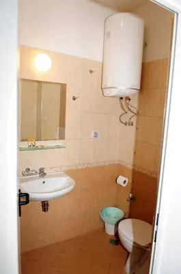 a bathroom with a sink and a toilet and a mirror at Студия Давидов 