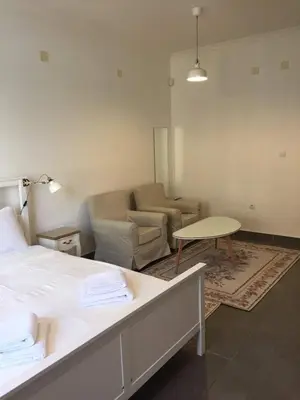 a room with a bed and a couch and a table at Студия Давидов 