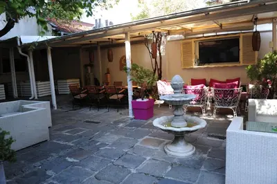 a stone patio with a fountain in a yard at Студия Давидов 