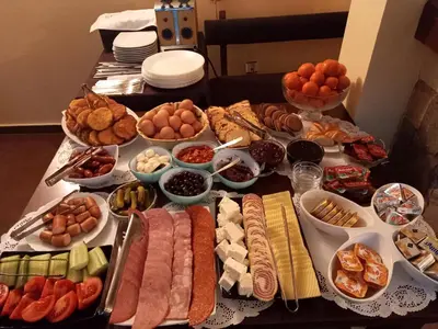 a table topped with lots of different types of food at Guest house Skabrin in Bansko