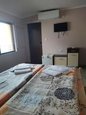 a room with a bed with a blanket on it at ИВАНЕЛИ in Sapareva Banya