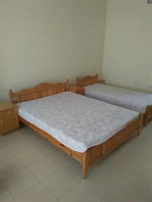 two beds are sitting in a room with at ИВАНЕЛИ in Sapareva Banya