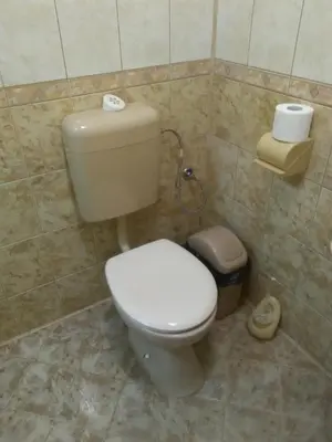 a bathroom with a toilet in a tiled room at ИВАНЕЛИ in Sapareva Banya