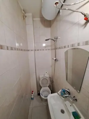a bathroom with a toilet and a sink and a mirror at relax in Plovdiv