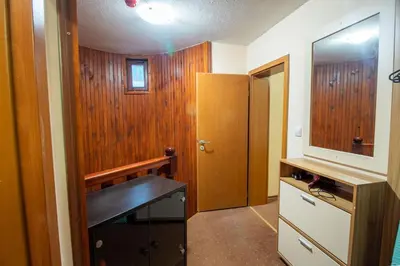 a bathroom with a desk and a mirror and a door at Ski Chalets at Pamporovo - an affordable village holiday for families or groups in Pamporovo