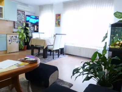 a living room with a table and a dining room at Art31 in Sofia