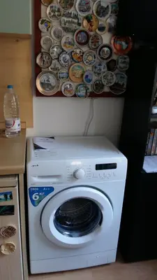 a washing machine in a kitchen with a picture on the wall at Art31 in Sofia