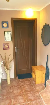 a door in a room with a vase and a table at Andro Apartments in Sofia
