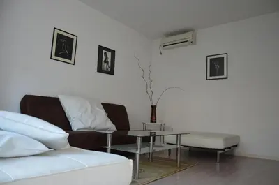 a living room with a couch and a table at Bulhotel Pritzker Apartment in Sofia