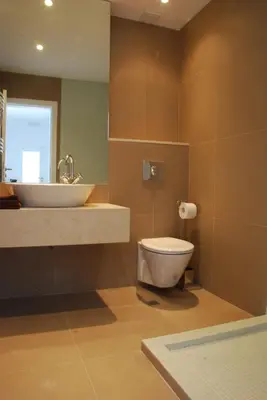 a bathroom with a white toilet and a sink at Bulhotel Pritzker Apartment in Sofia