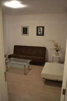 a living room with a couch and a coffee table at Bulhotel Pritzker Apartment in Sofia